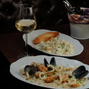 Business dining experience featuring Mexican seafood and white wine.