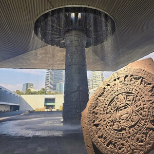 The iconic umbrella fountain and the Aztec Sun Stone at the National Museum of Anthropology in Mexico City.